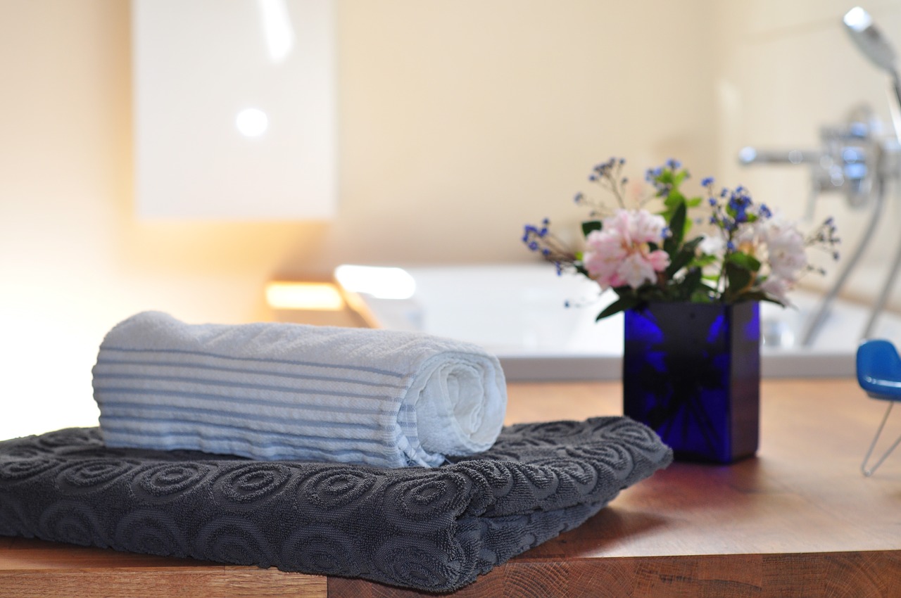 Towels and flowers in bathroom.